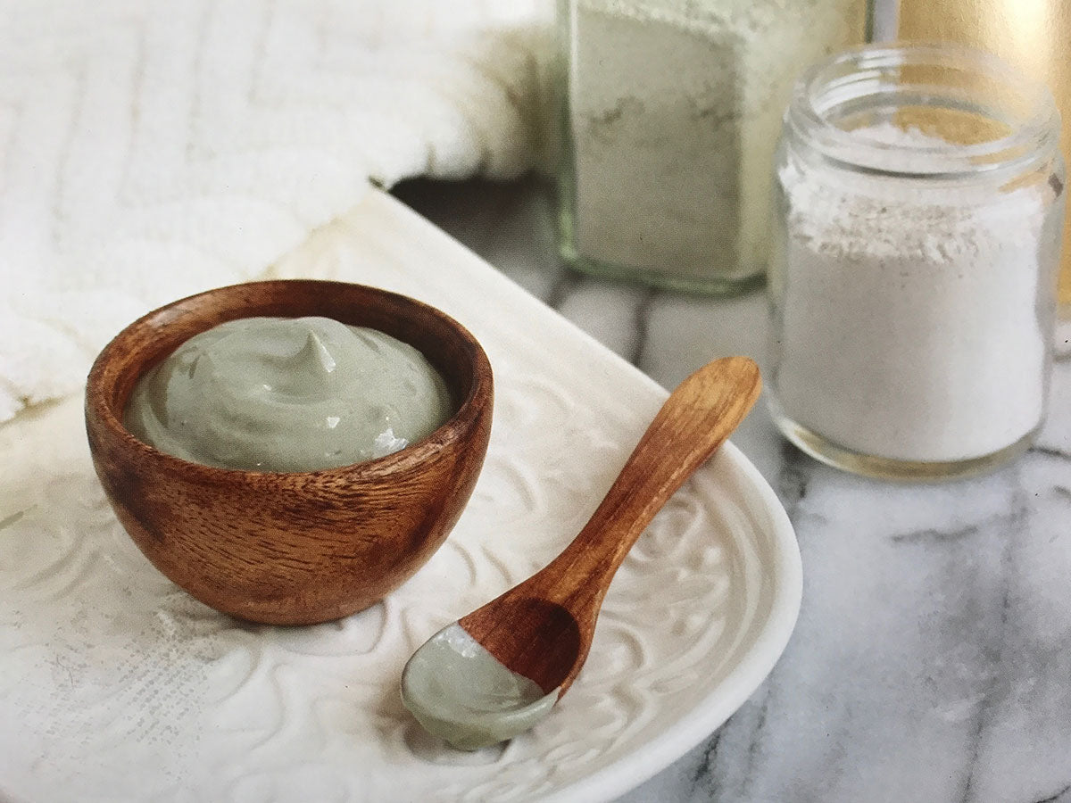 Wooden Bowl with green clay mixture for face mask application